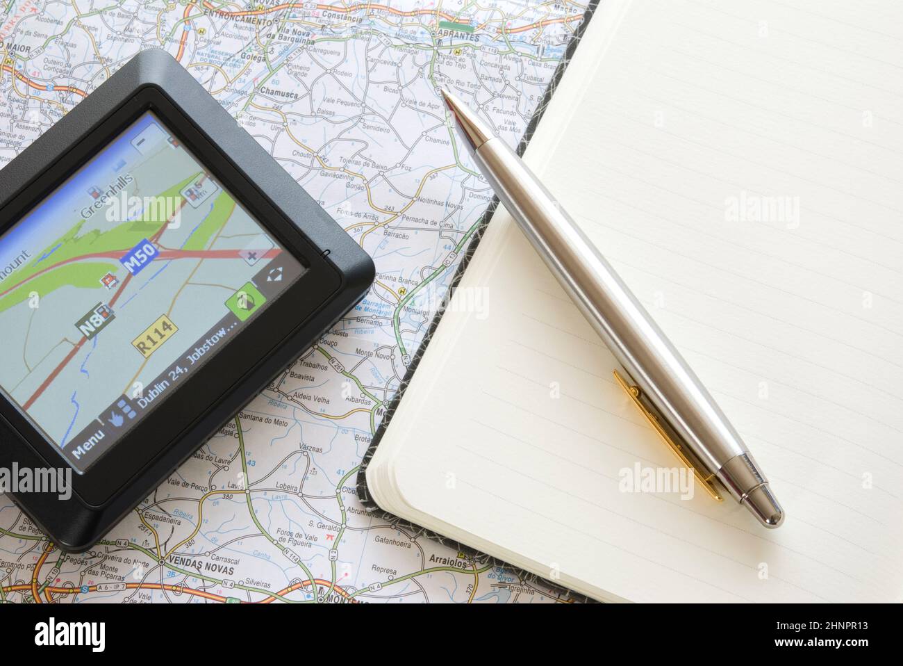GPS global positioning device with notebook, ballpoint and map Stock