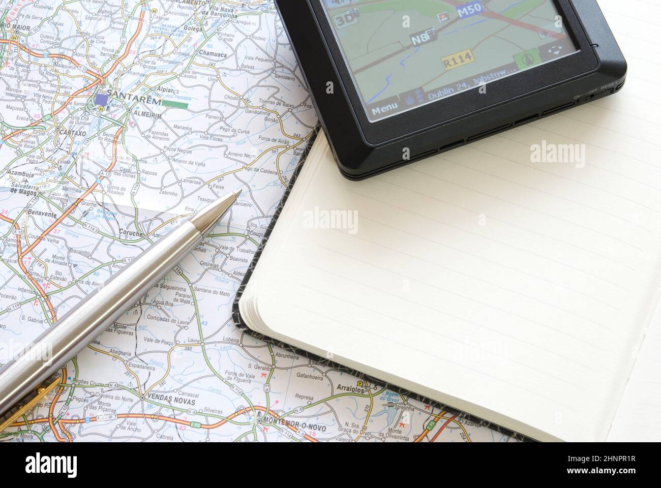 GPS global positioning device with notebook, ballpoint and map Stock