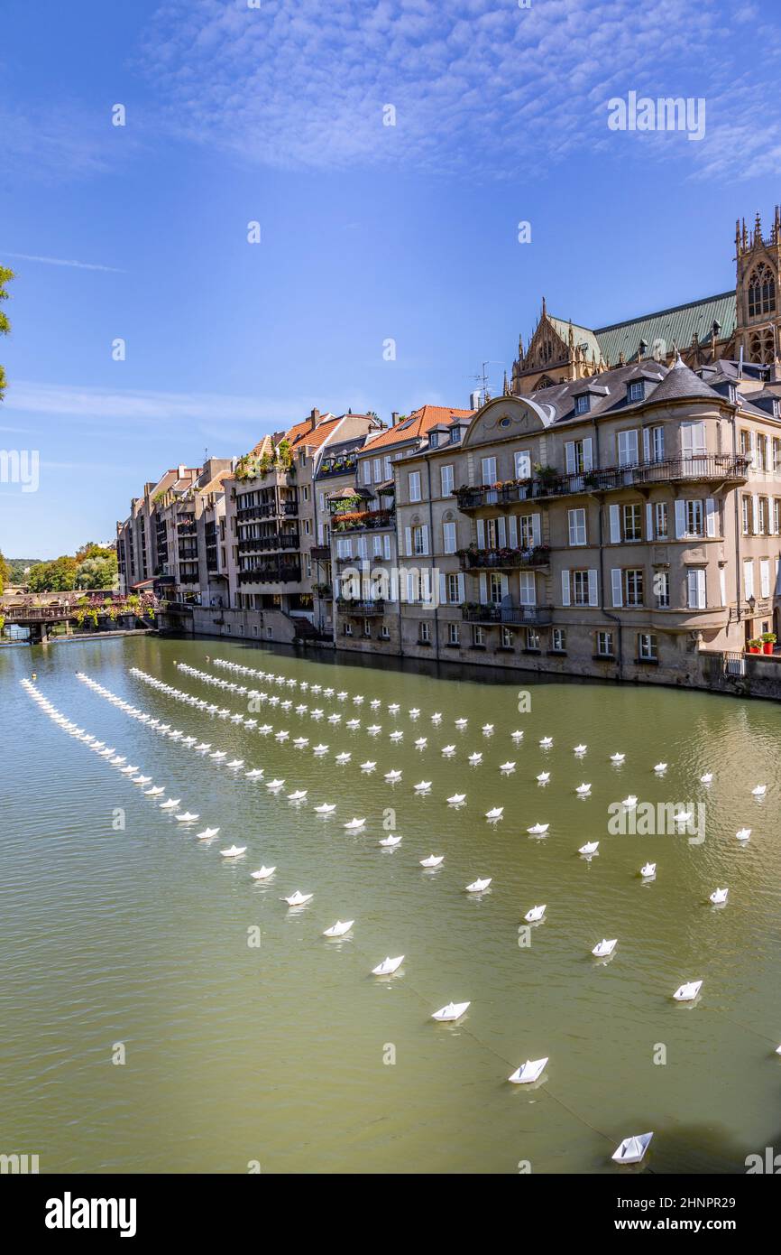folded small plastic ships cover the moselle at Metz in an organized structured way Stock Photo