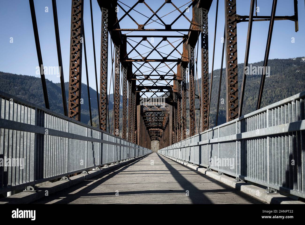 An old steel bridge repurposed into a walking path near Clark Fork, Idaho. Stock Photo