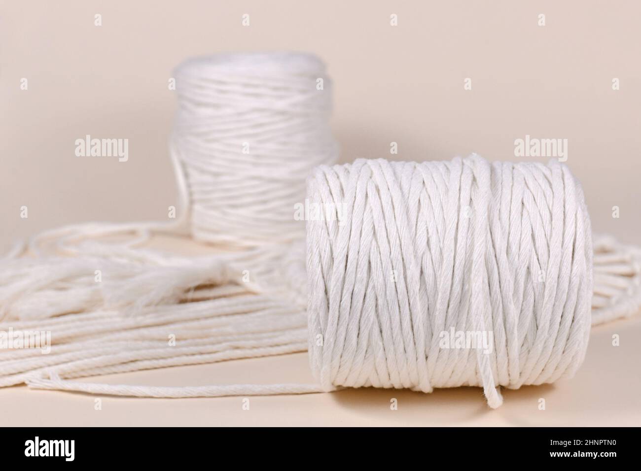 Cotton macrame cord used for DIY decoration object on beige background Stock Photo