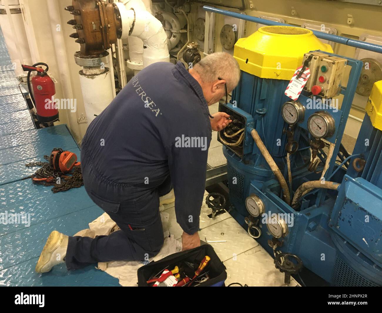 ships crew doing electrical motor repair,bearing replacement of