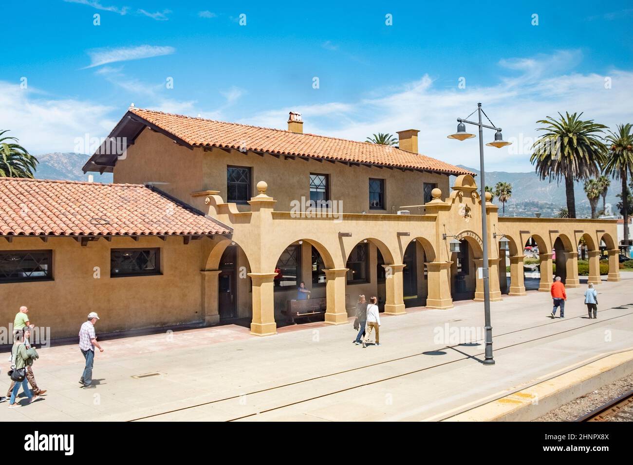 people wait for the pacific surfliner train at old mexican style Santa Barbara station Stock Photo