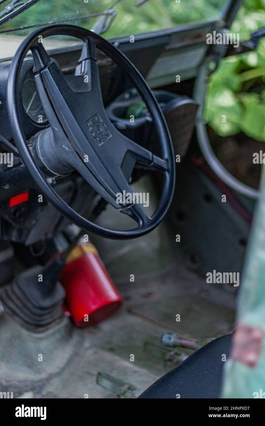 Vertical shot of a steering wheel of an old vintage Jeep SUV sports vehicle Stock Photo