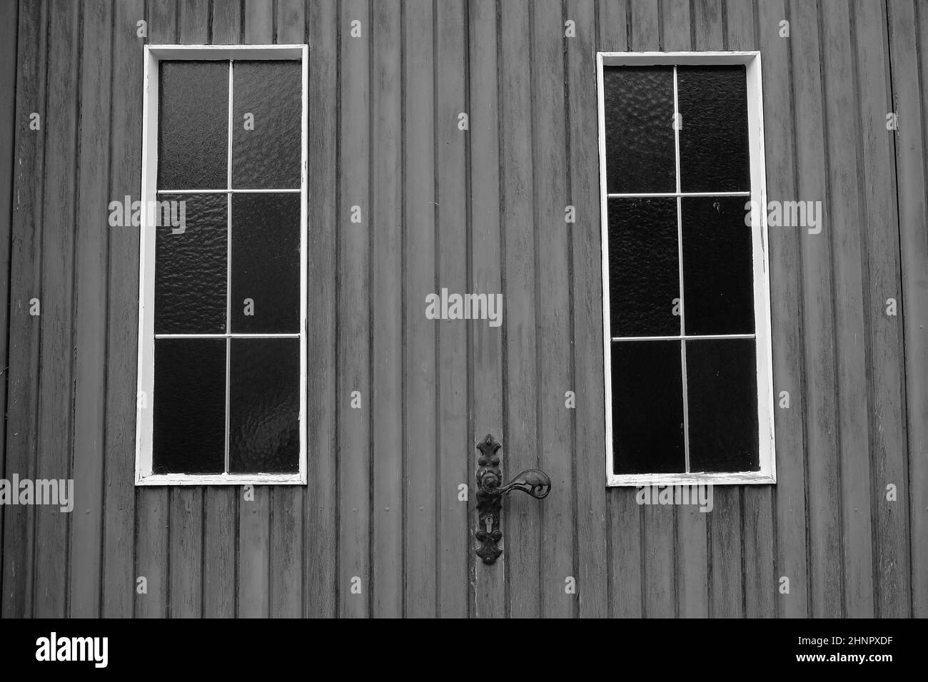 Black and white shot of a wooden door with windows Stock Photo - Alamy