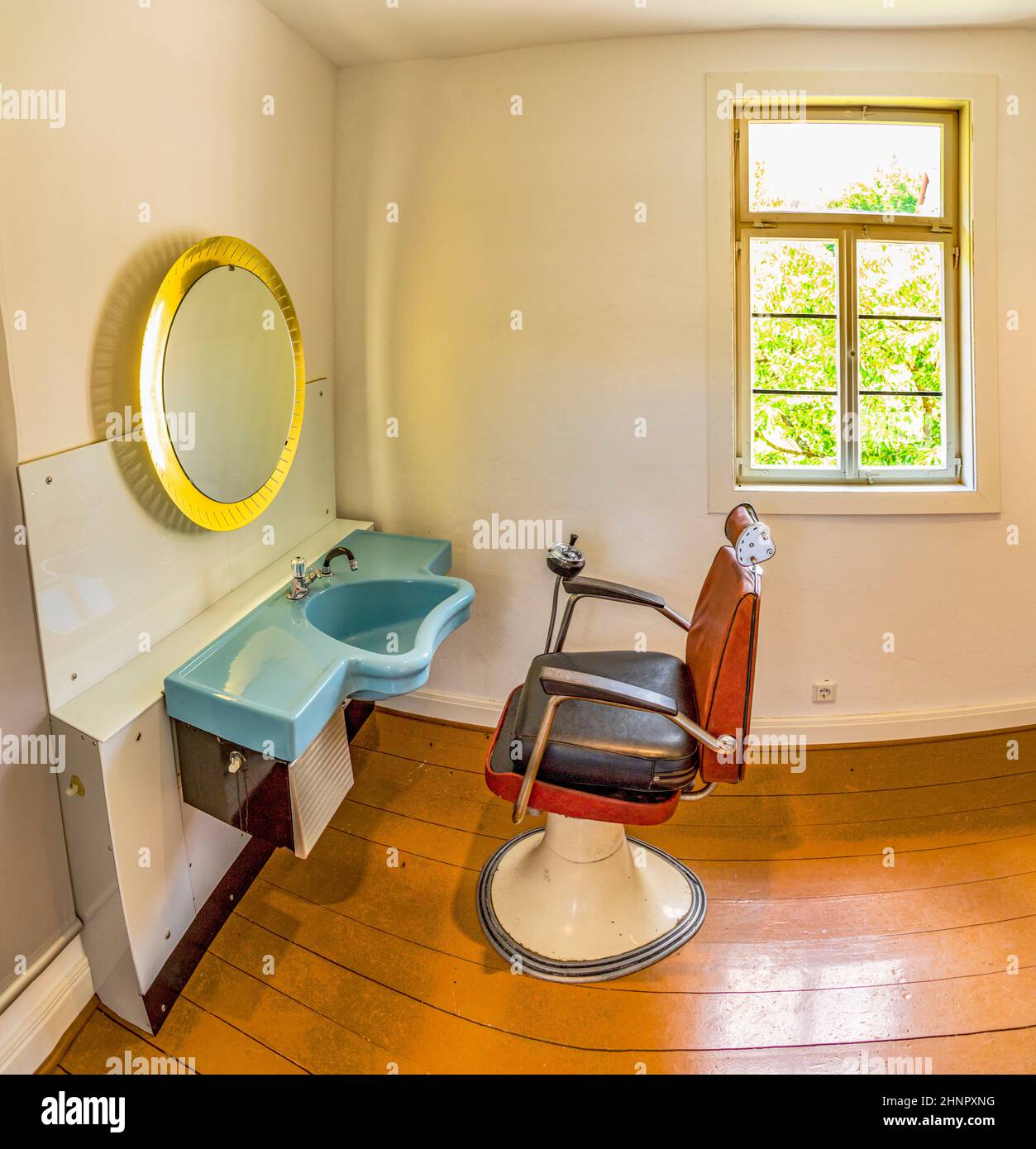 vintage chair and sink of a hair stylist in the architecture style uf the 50th of last century in the Hessenpark Stock Photo