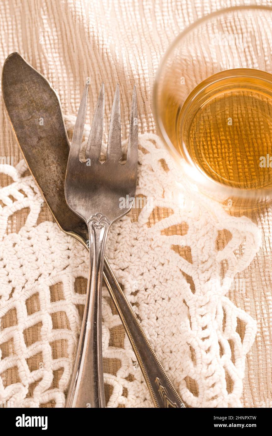 A concept photo of old tarnished fork and butter knife on the table