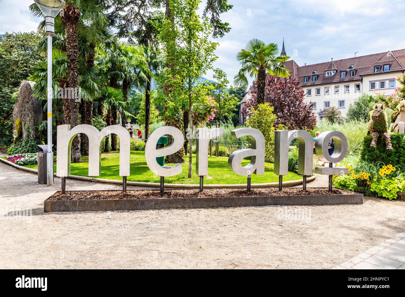Glimpse of the historic center of Merano with Merano in metal letters in, Meran, Bolzano, Trentino Alto Adige, Italy Stock Photo