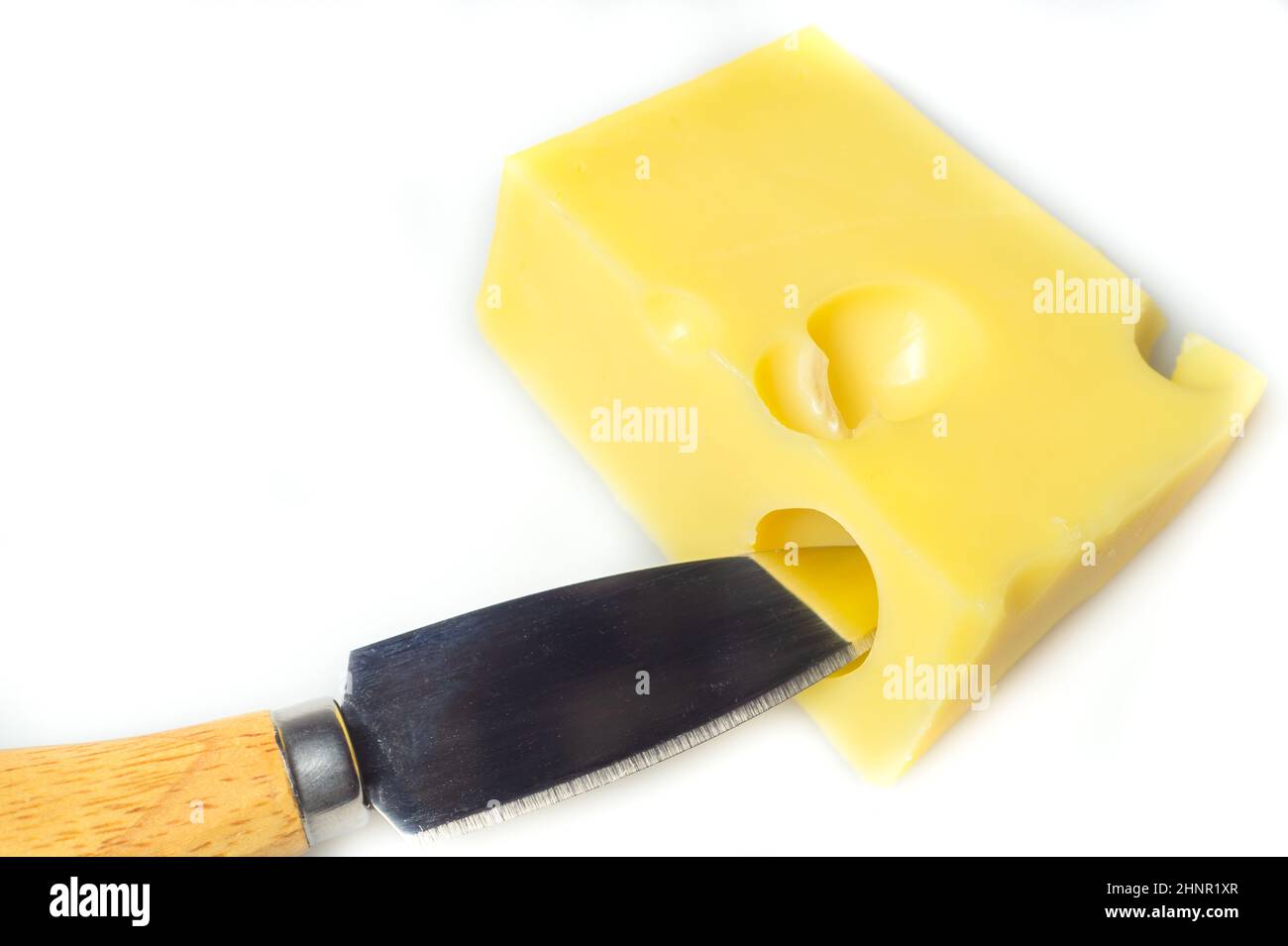 Cheese with a cheese knife isolated on white. piece of cheese with