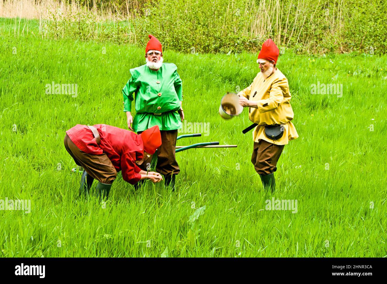 three garden gnomes enjoy children at the festival for inauguration the New Quellenpark Stock Photo