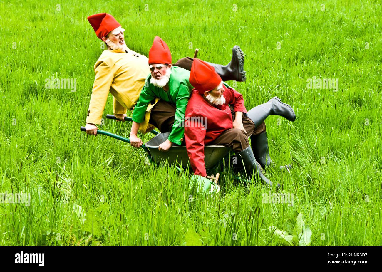 three garden gnomes enjoy children at the festival for inauguration the New Quellenpark Stock Photo