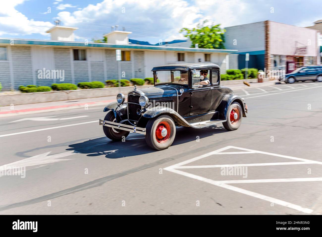 Ford vintage car driving through the streets Stock Photo