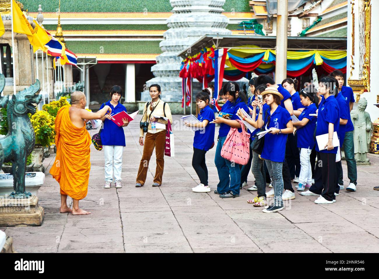 buddhist monk explains the secrets of temple area Wat Pho Stock Photo