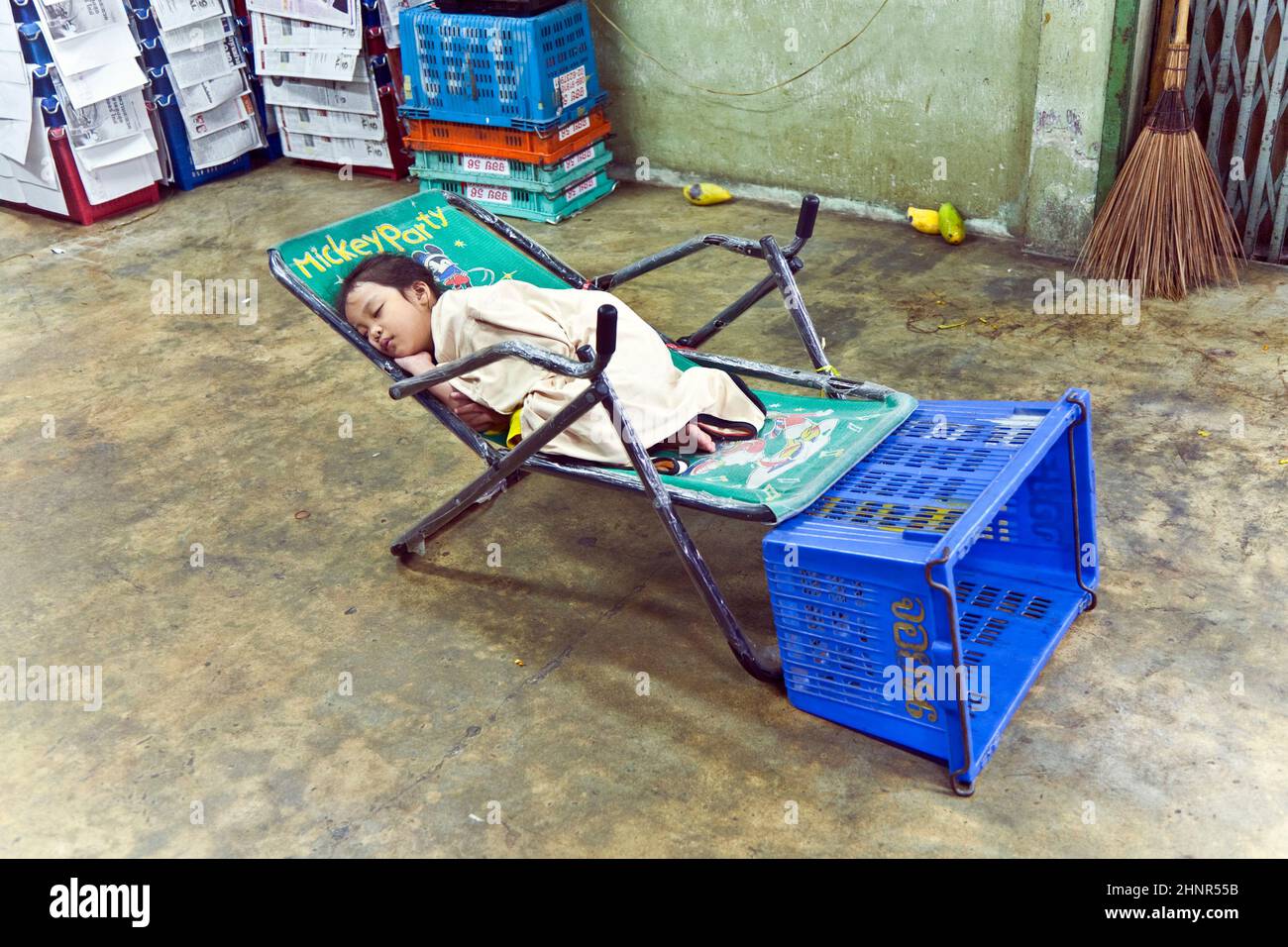 unidentified young girl sleeps in the shop of the flower market Stock Photo