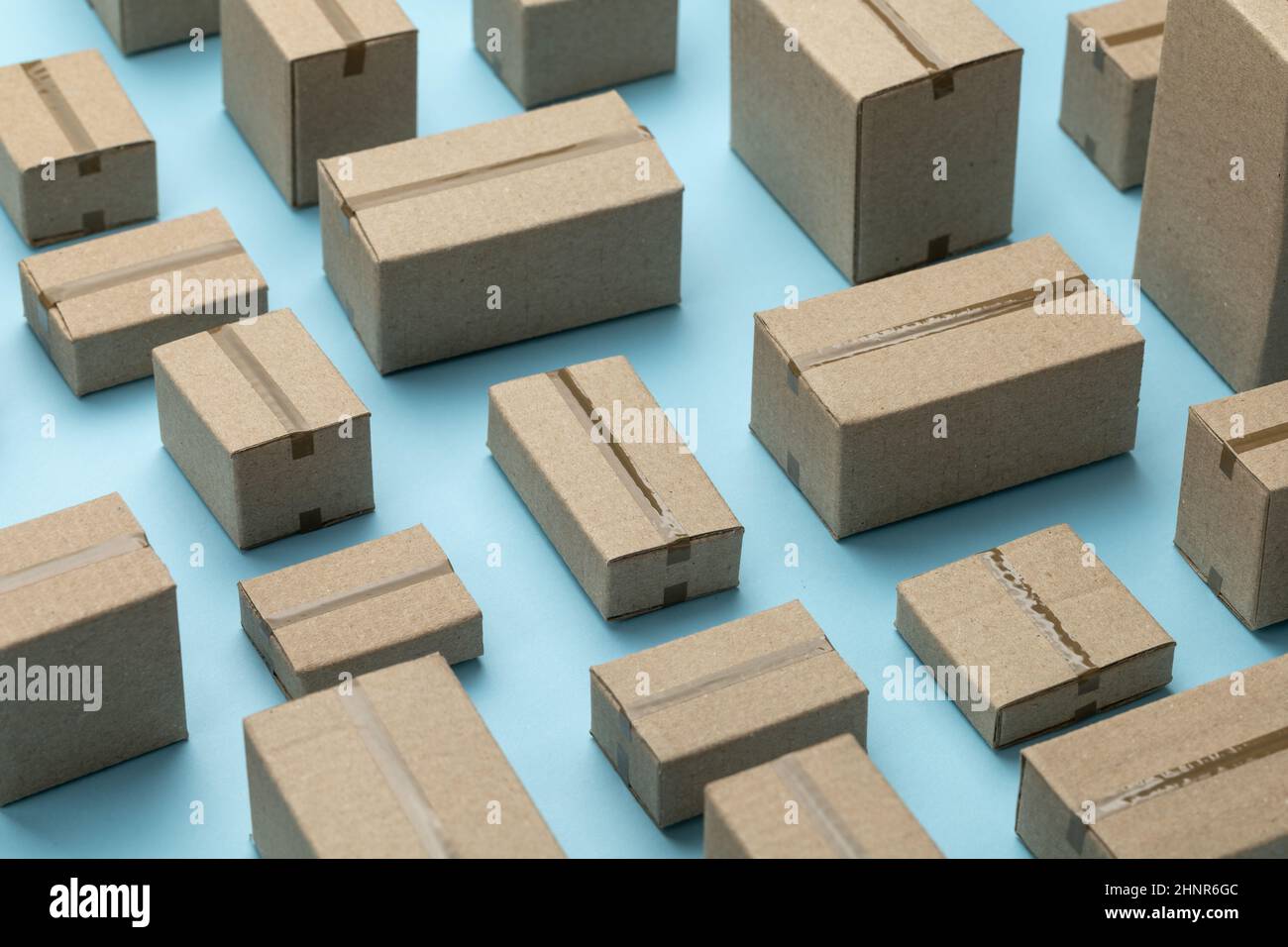 Lots of cardboard boxes pattern on a blue background. Stock Photo