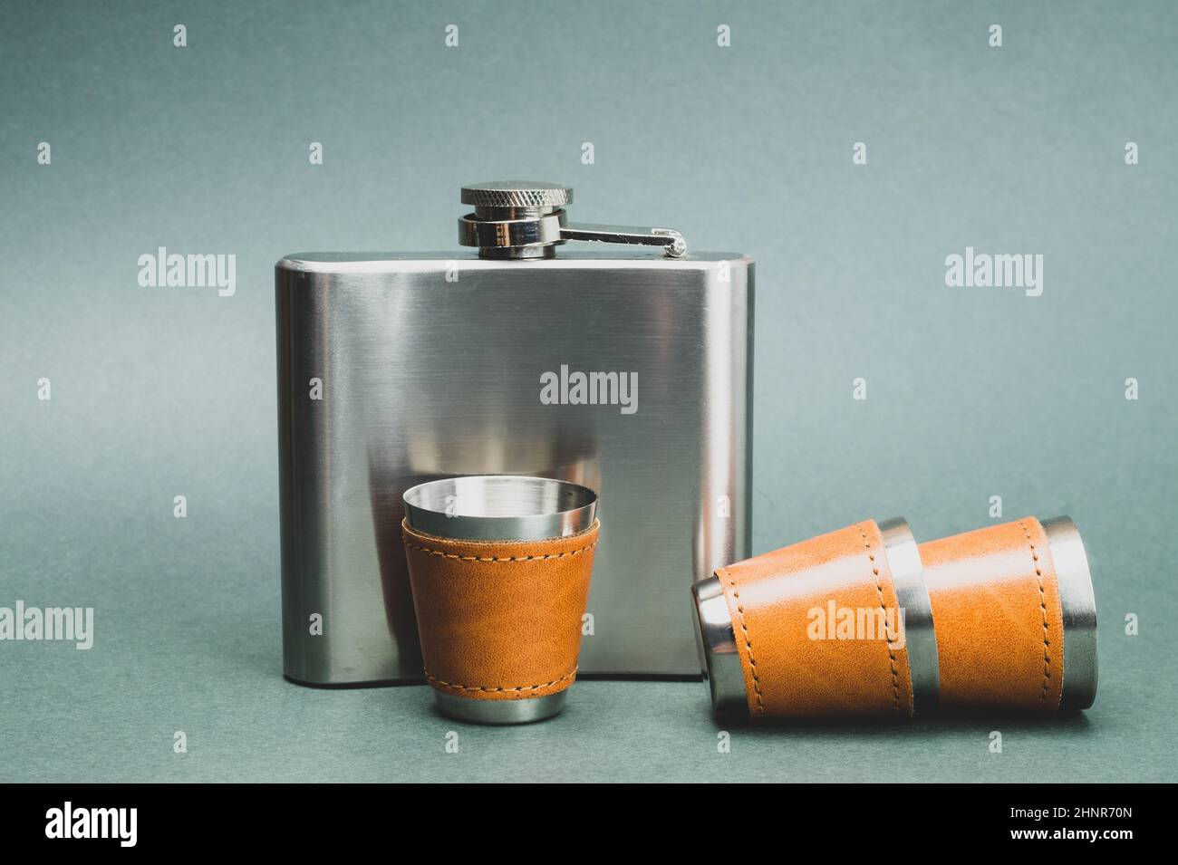 Metallic shot glasses and flask. travel shot glass for alcohol with leather casing over the