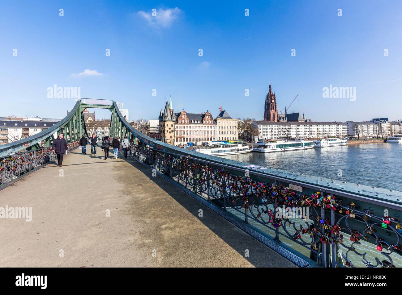 people at Famous Eiserner steg with love locks over the river Main Stock Photo