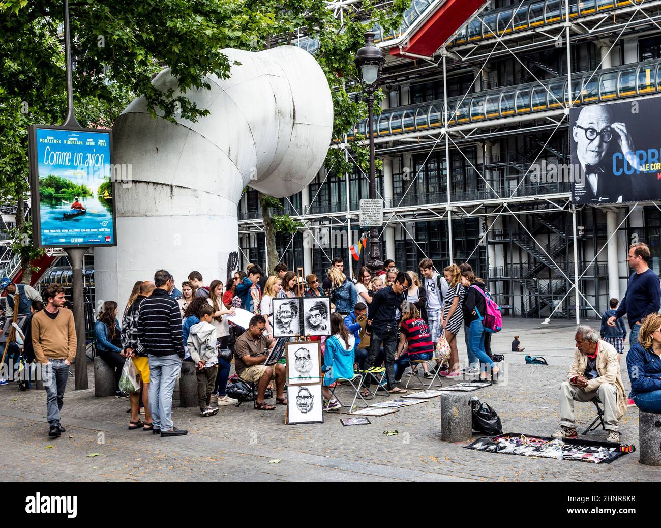 young people at centre pompidou have fun being drawed by artists Stock Photo