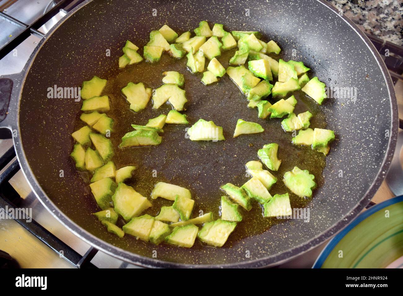 preparing sutéed zucchini in pan with olive oil Stock Photo Alamy
