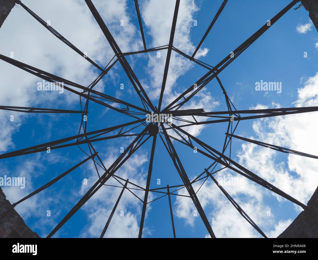 View of the sky through a ruined roof construction. steel carcass for roof mounting Stock Photo