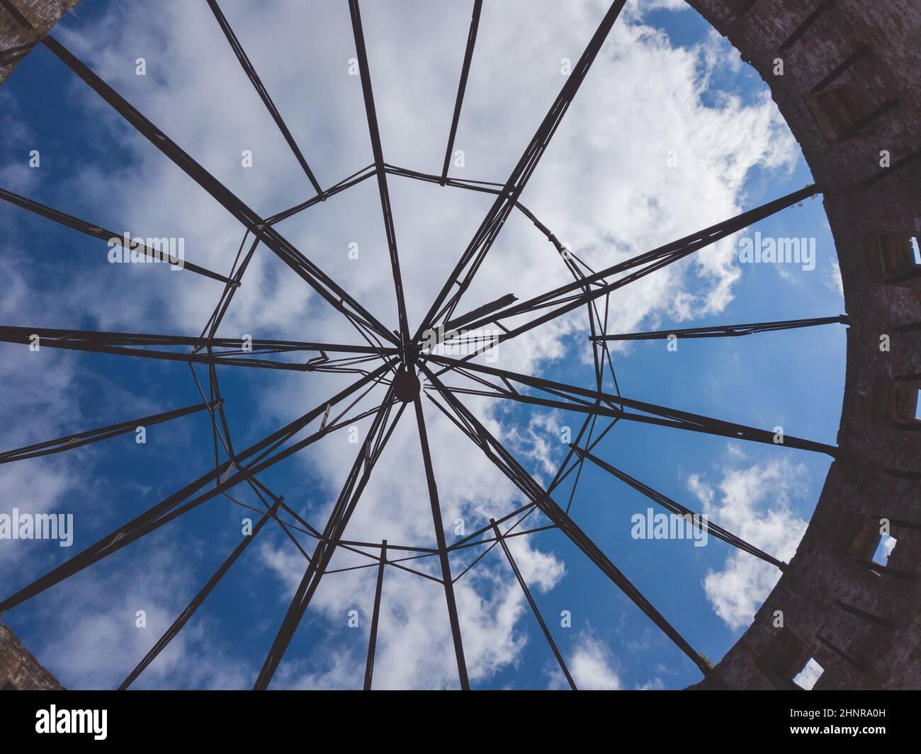 View of the sky through a ruined roof construction. steel carcass for roof mounting Stock Photo