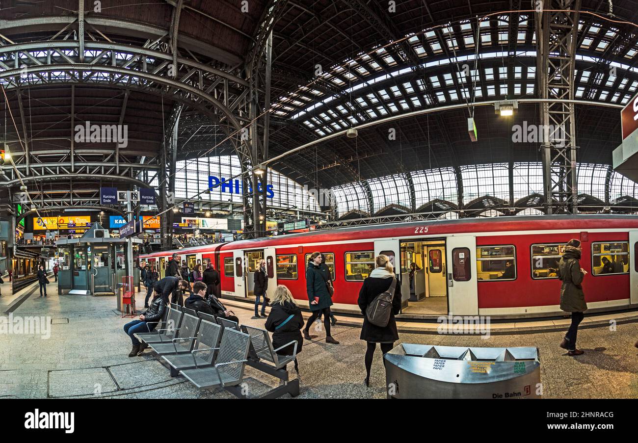 people in the morning wait for the train in the central station in Hamburg Stock Photo