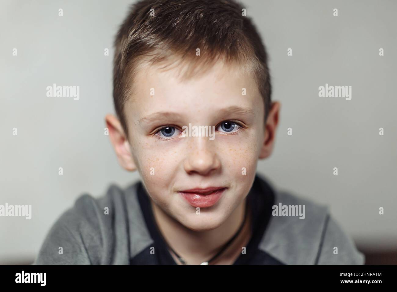 close-up portrait of serious caucasian boy with freckles in casual wear, boy looking in camera Stock Photo