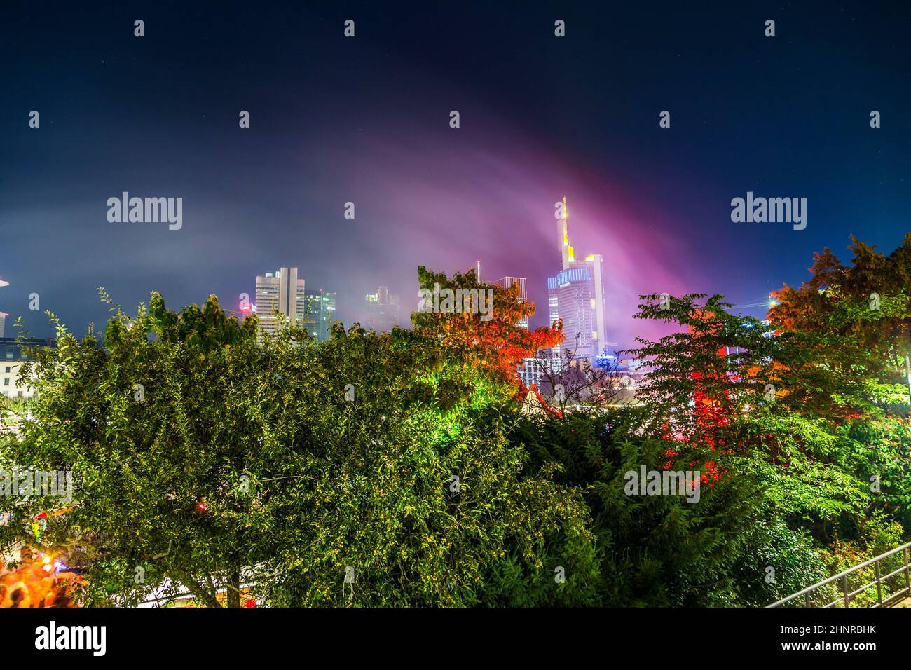 skyline of Frankfurt with light installations in the trees at  the museum festival in Frankfurt Stock Photo