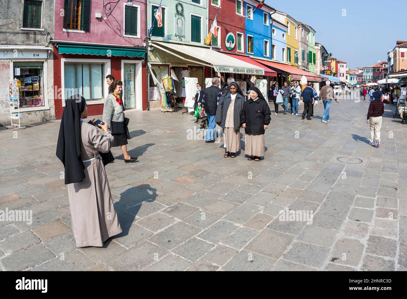 nuns on a touristic tour at the venice island of Murano take a photo as souvenir Stock Photo