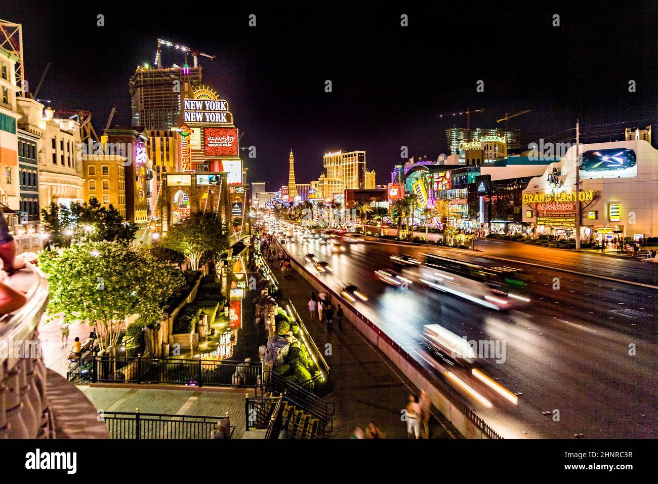 View to the Strip in Las Vegas by night with cars on the street and neon lights Stock Photo