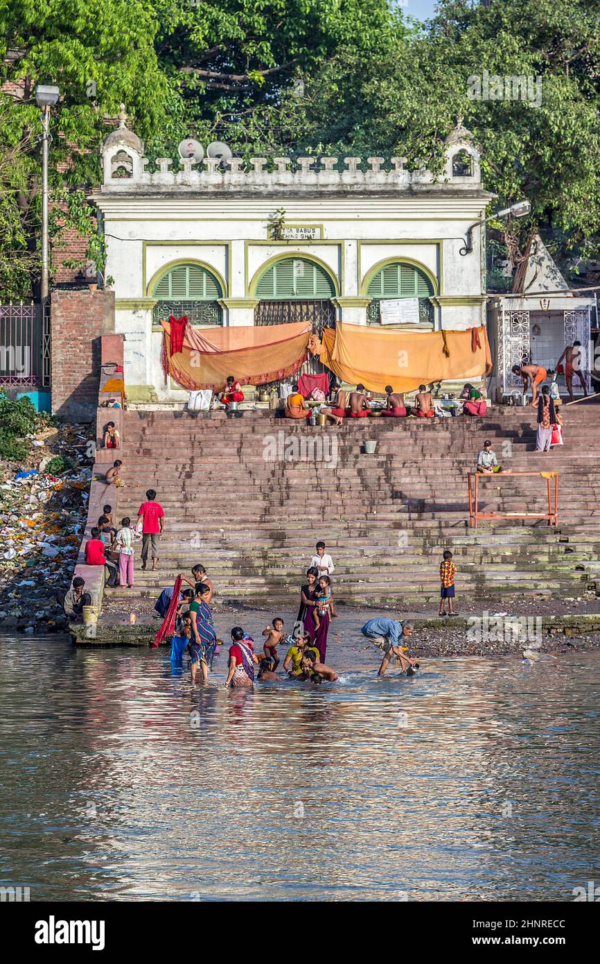 people cleaning clothes and washing in the river Ganges in Calcutta Stock Photo