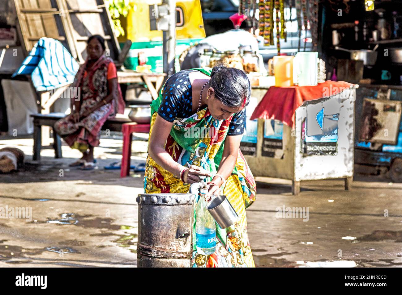 woman gets clean water from a hydrant in the old part of Calcutta Stock Photo