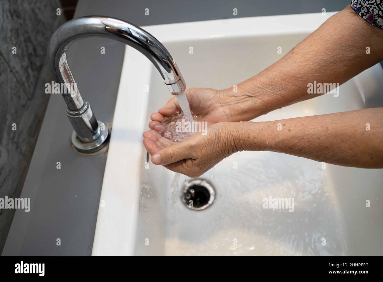 Asian washing hand by soap and clean water for protect safety infection