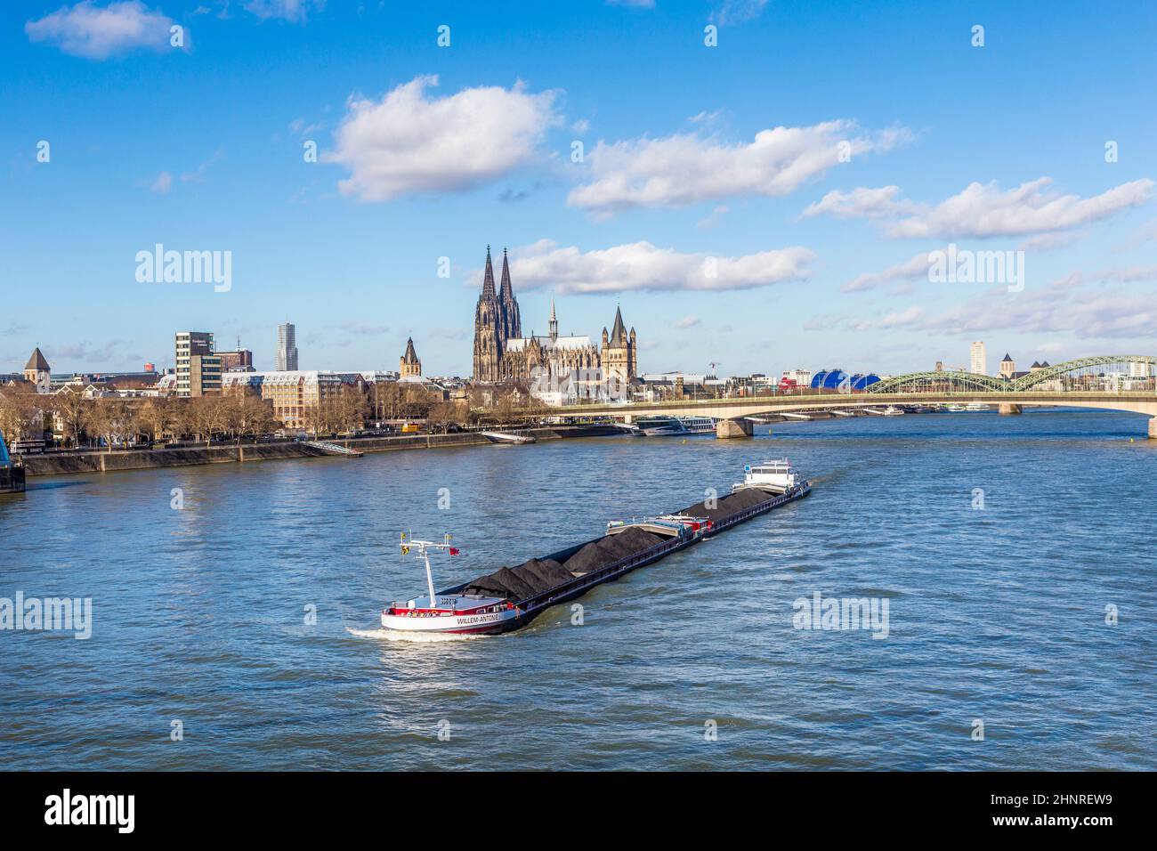Cologne skyline with dome and bridge and ship on river Rhine Stock Photo