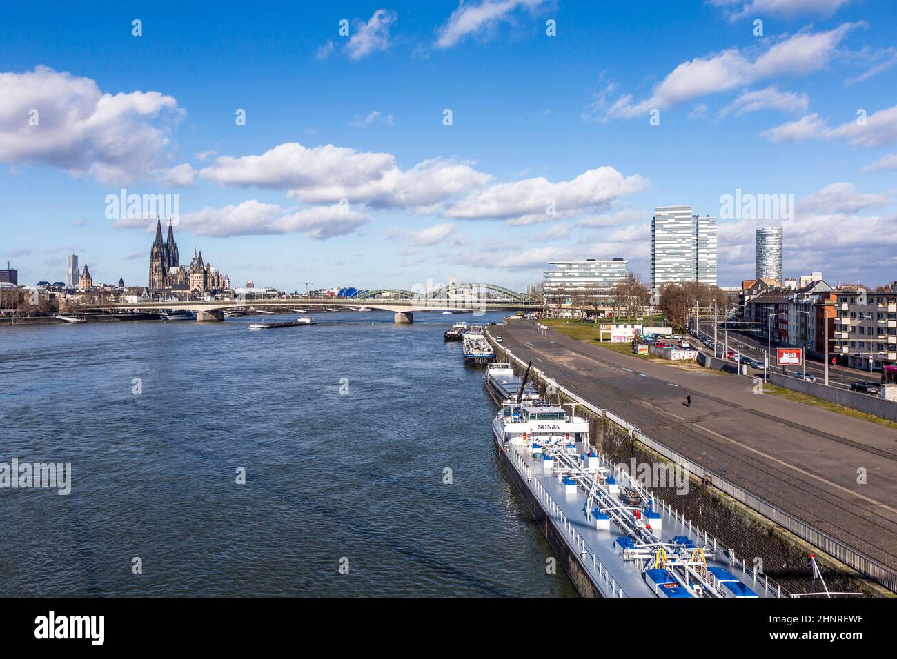 Cologne skyline with dome and bridge and ships on pier Stock Photo