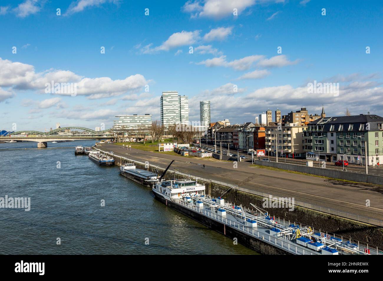 Cologne skyline with dome and bridge and ships on pier Stock Photo