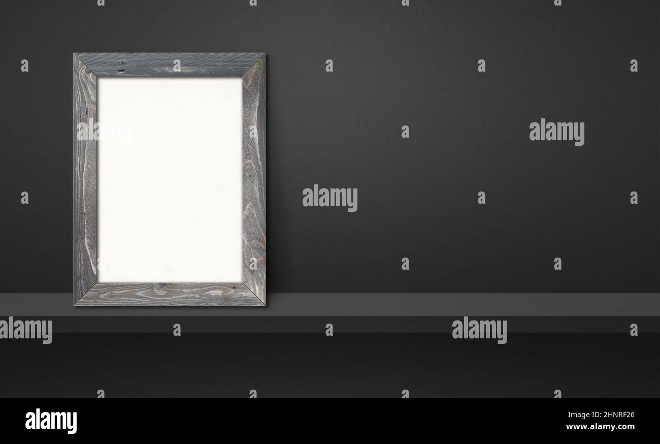Wooden picture frame leaning on a black shelf. 3d illustration. Blank ...