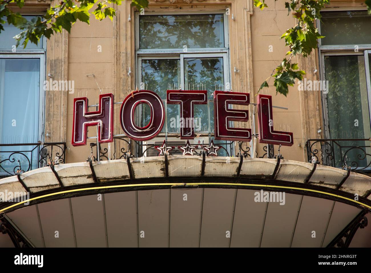sign Hotel at an old facade in red letters in Aix en Provence Stock Photo