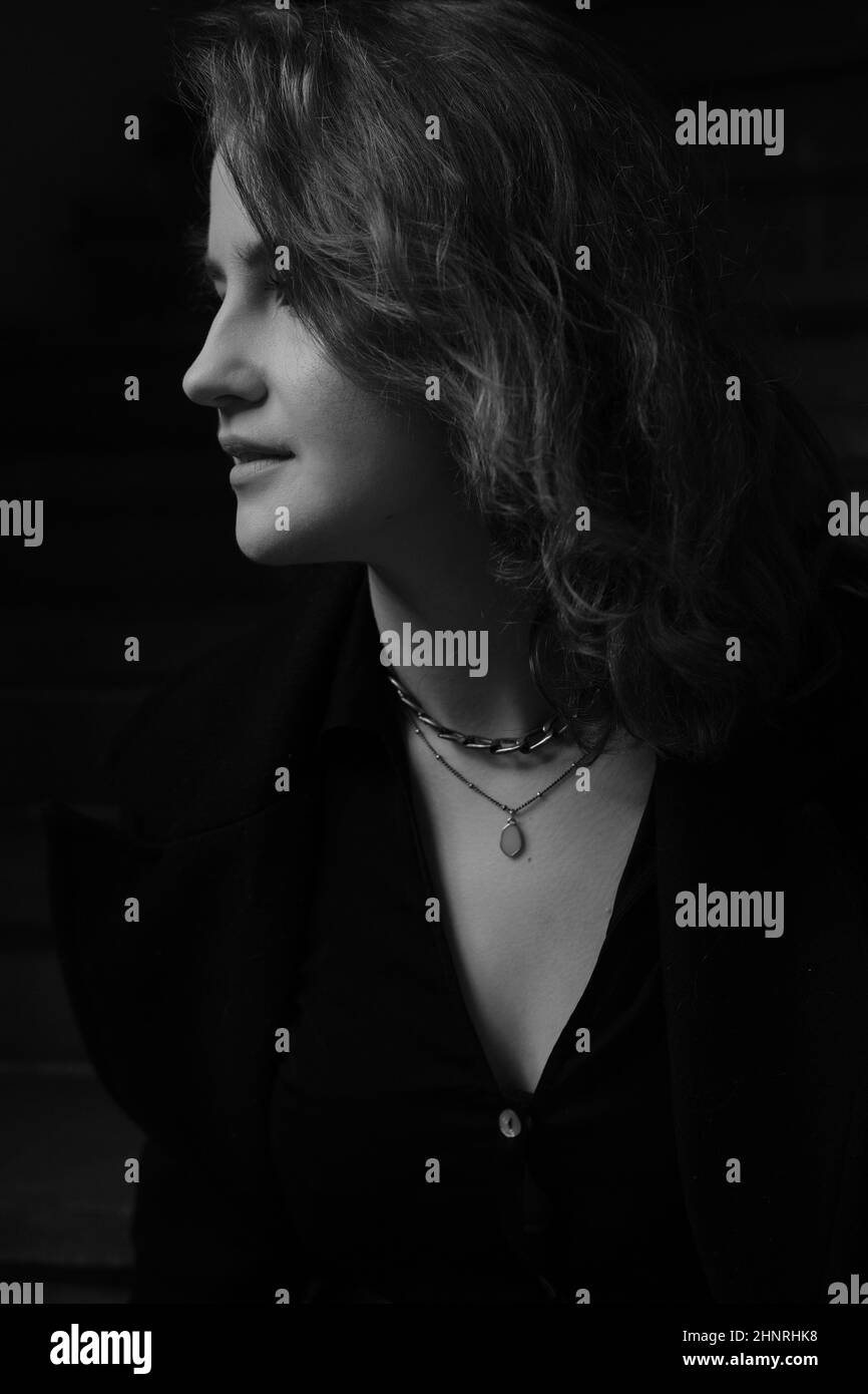 A young girl dressed in a black autumn coat Stock Photo - Alamy