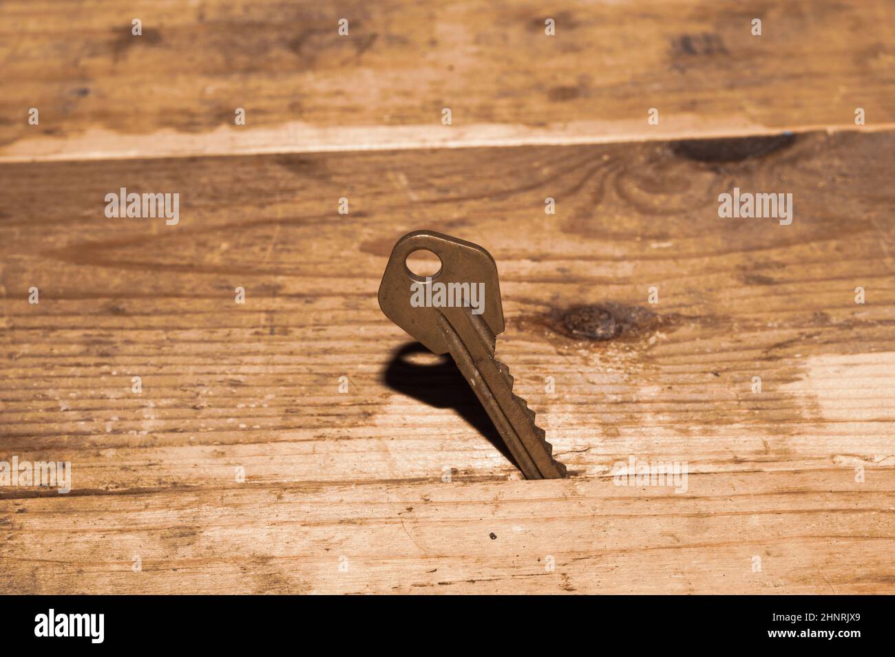 Key stuck in the table. key on wooden background. safety and security