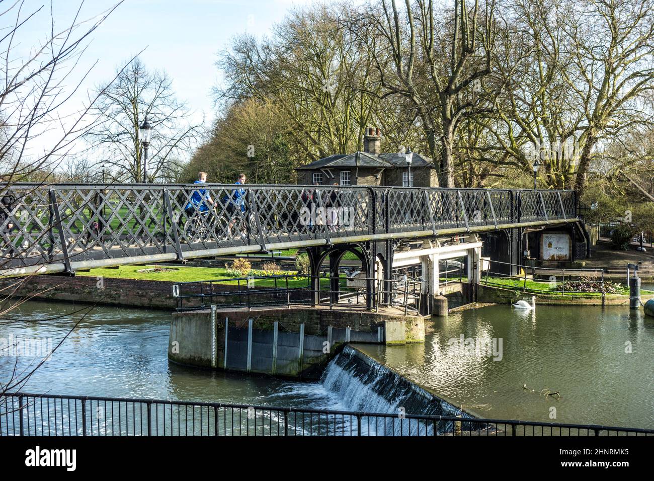 people crossing the river cam at an old iron pedestrian bridge Stock Photo