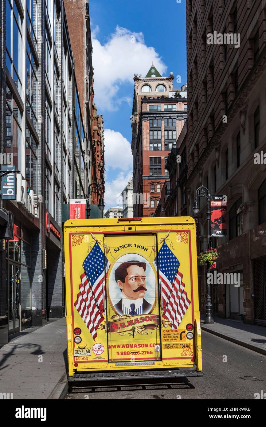 streetlife downtown New York. The parcel service mason with its vintage painted yellow trucks deliveres parcels Stock Photo