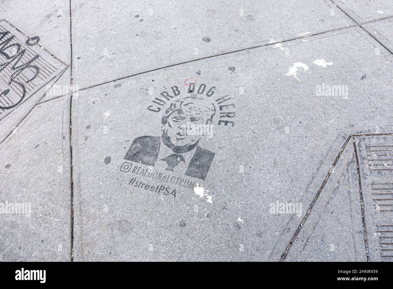 satiric print of face of Donald trump at the sidewalk Stock Photo