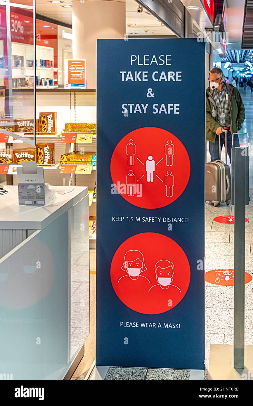 sign please take care and stay safe at Frankfurt Airport. Stock Photo