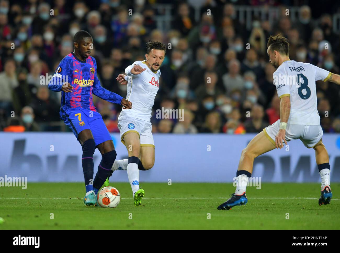 Barcelona,Spain.17 February,2022. Ousmane Dembele (7) of FC Barcelona  dribbles (06) Mario Rui of Napoli and (08) Fabian Ruiz of Napoli during the Europa  League match between FC Barcelona and SSC Napoli at