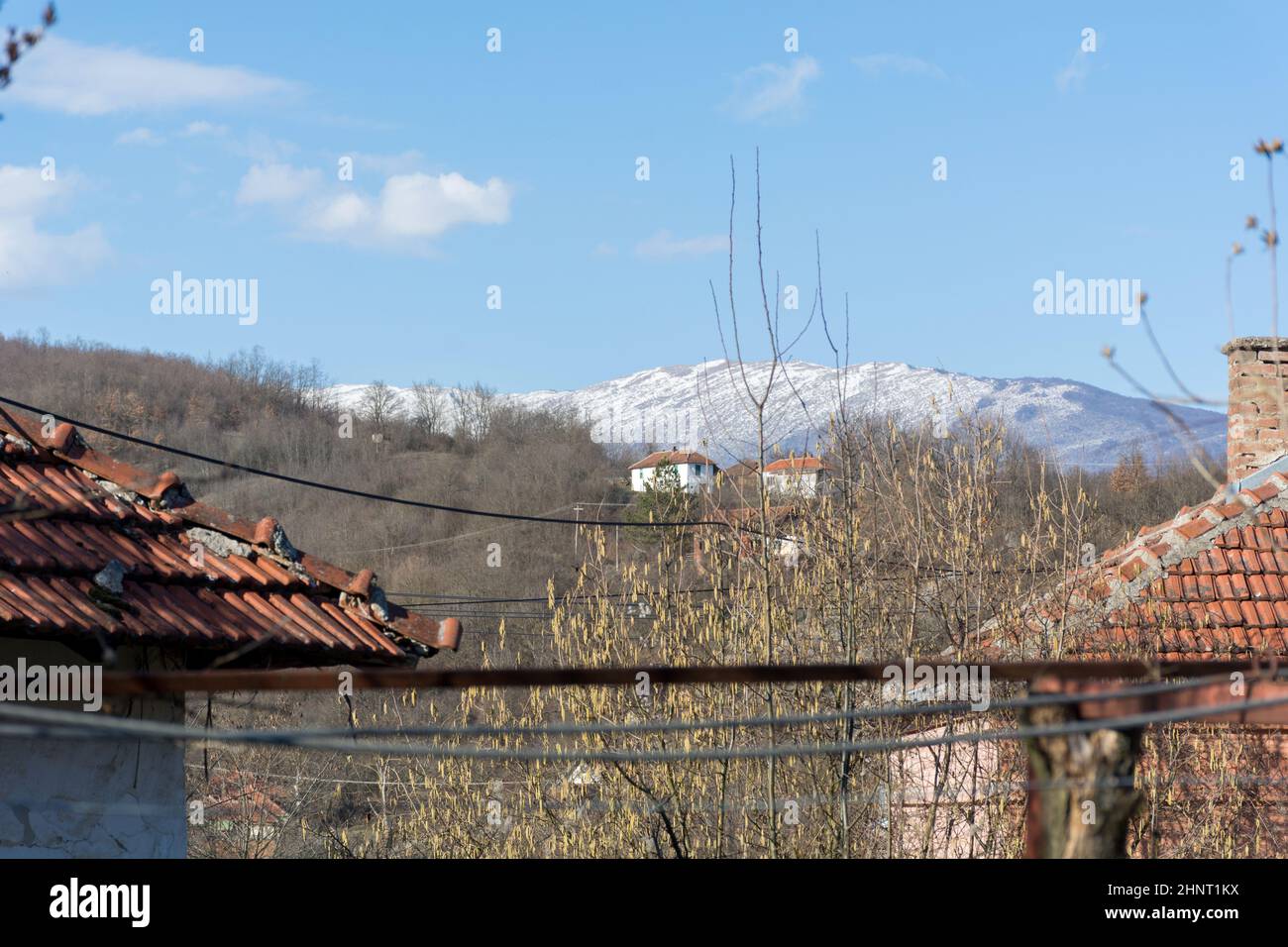Malo Bonjince, Serbia - February 15. 2022 Beautiful view of the mountain top covered with snow on Suva Planina from the village yard on a winters day Stock Photo