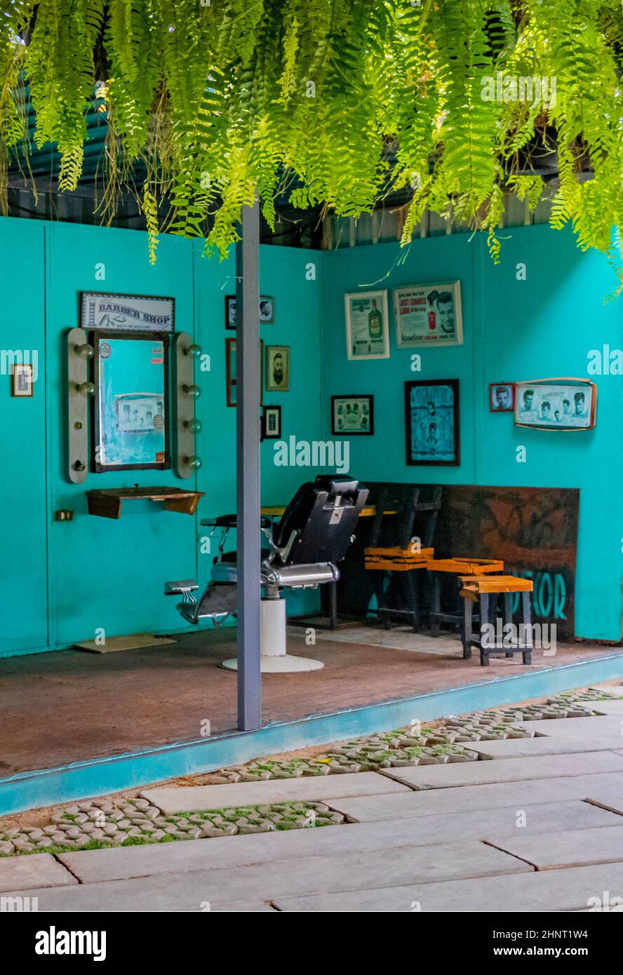 Empty turquoise hair salon and barber shop interior Bangkok Thailand. Stock Photo