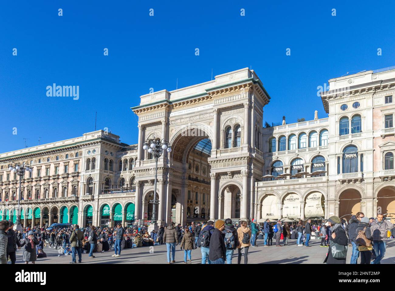 people visit the central square of Milan, the place of the cathedral on a cold winter day Stock Photo
