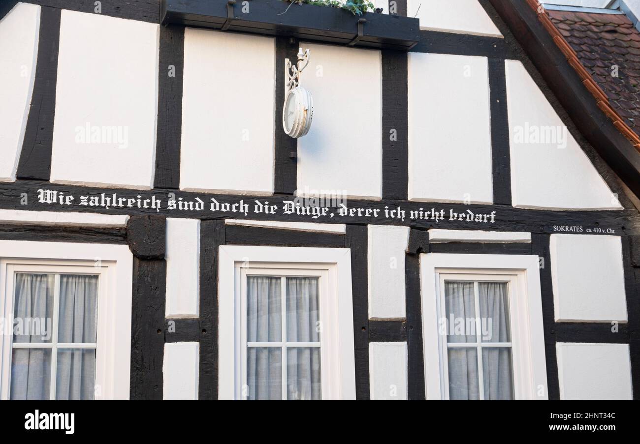 half timbered house with inscription from Sokrates - what a lot of things I dont need Stock Photo
