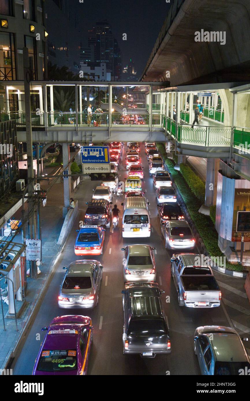 main road in Bangkok in nightly traffic jam with cars Stock Photo